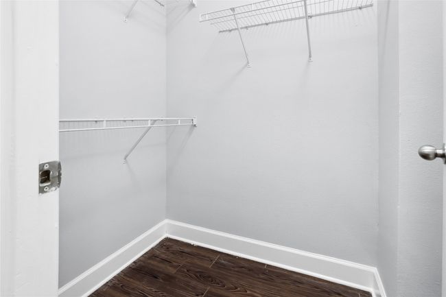 Walk in closet with dark wood-style flooring | Image 20