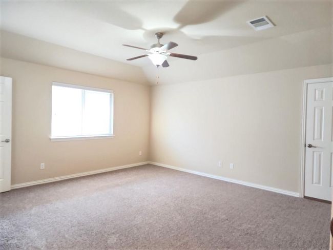 Empty room featuring carpet floors, a ceiling fan, and baseboards | Image 24