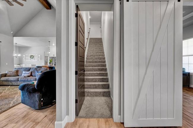 Staircase featuring wood finished floors and a ceiling fan | Image 47