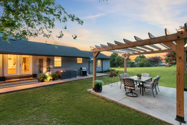 Yard at dusk featuring a yard, a patio, and a pergola | Image 37