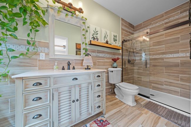 Kitchen featuring stainless steel appliances, a kitchen breakfast bar, tasteful backsplash, recessed lighting, and a sink | Image 15