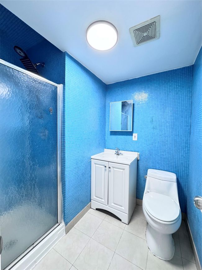 Full bathroom featuring a stall shower, vanity, and tile patterned floors | Image 16