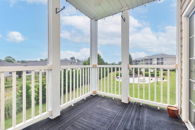 Wooden deck with a residential view and a yard | Image 13