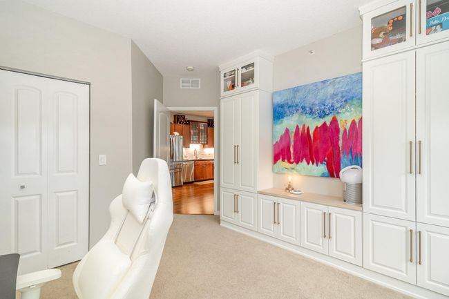 Second bedroom is conveniently located and filled with beautiful white cabinetry! | Image 17