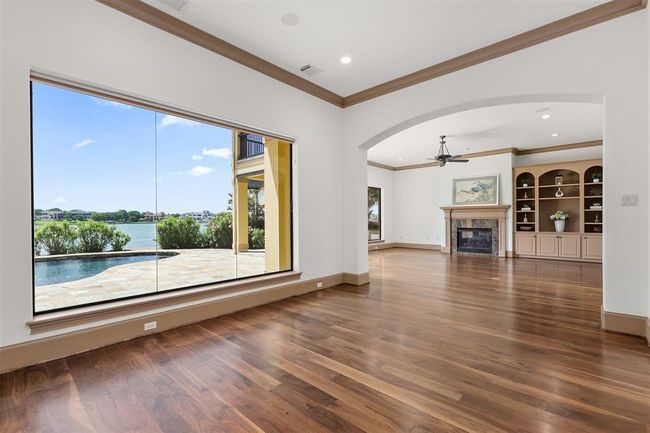 The open floor plan seamlessly connects the plush living area with the sophisticated dining space, creating an ideal setting for upscale entertaining and comfortable living. | Image 17