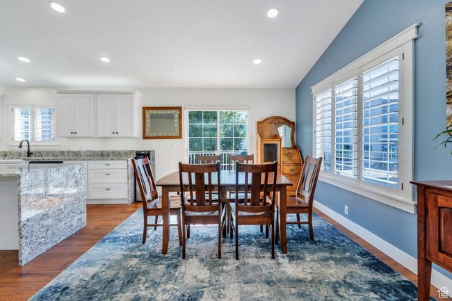 Dining space with dark wood-style flooring and recessed lighting | Image 4