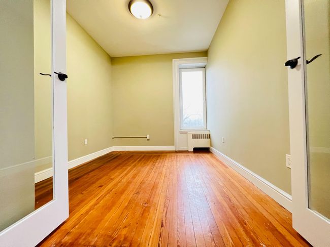Glass doors lead to the primary bedroom | Image 7