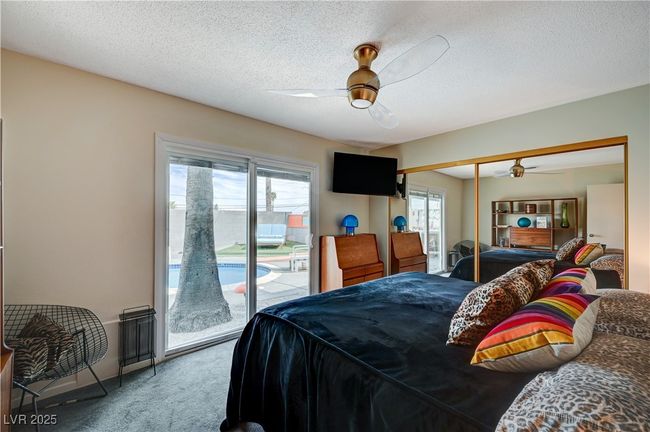 Carpeted bedroom featuring access to exterior, a closet, a ceiling fan, and a textured ceiling | Image 29