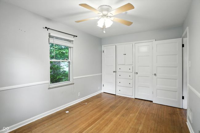 unfurnished bedroom with wood-type flooring and ceiling fan | Image 30