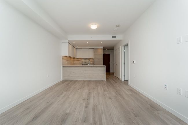 Unfurnished living room featuring recessed lighting, light wood-style floors, baseboards, and visible vents | Image 4