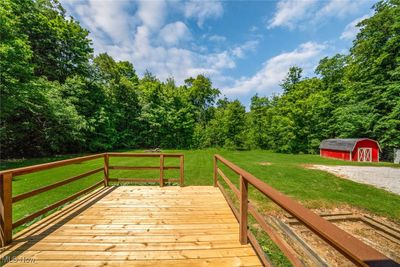 Deck with a storage unit and a lawn | Image 2