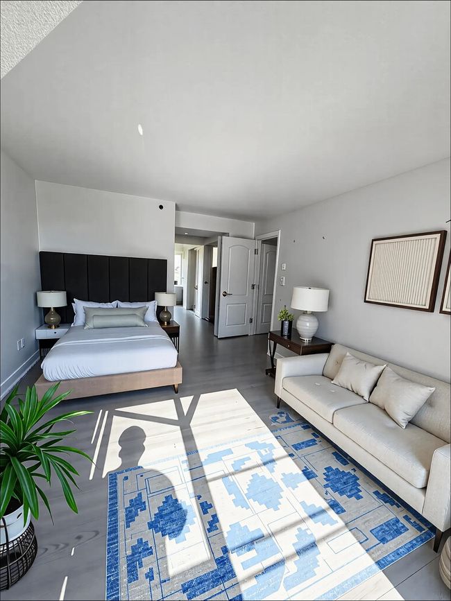 Bedroom with wood finished floors | Image 6