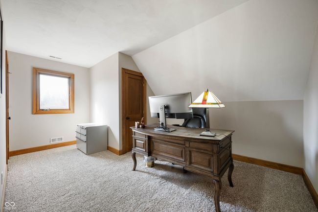 office area with lofted ceiling, visible vents, baseboards, and carpet floors | Image 27
