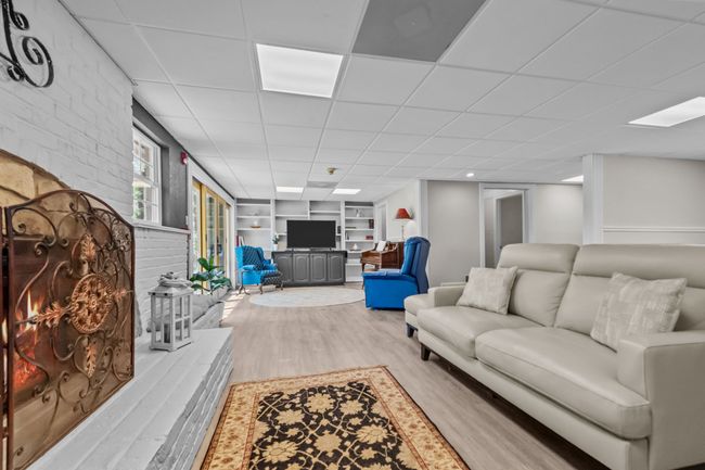 Living room featuring built in features, wood finished floors, and a drop ceiling | Image 8