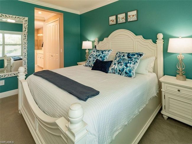 Carpeted bedroom with ensuite bathroom and ornamental molding | Image 10