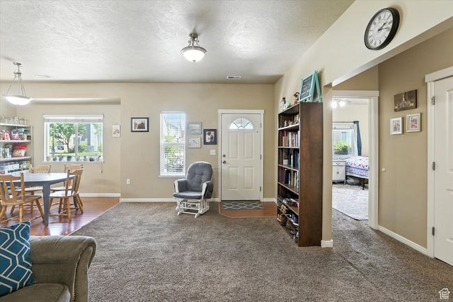 Living room featuring a textured ceiling and carpet | Image 4