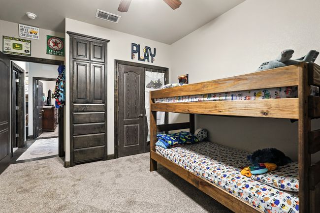 Bedroom with light carpet and a ceiling fan | Image 28