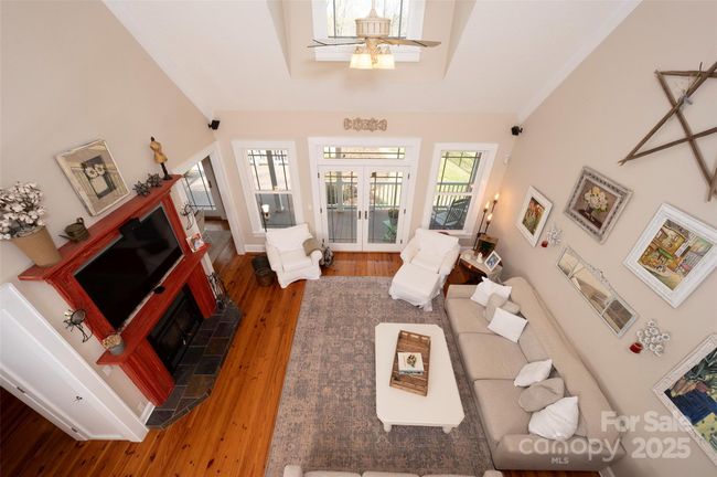 Two-story Great Room with Wood burning Fireplace, slate hearth, and custom mantel. | Image 6