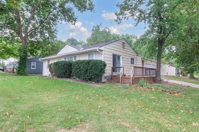 View of front of home with a front lawn and a deck | Image 1