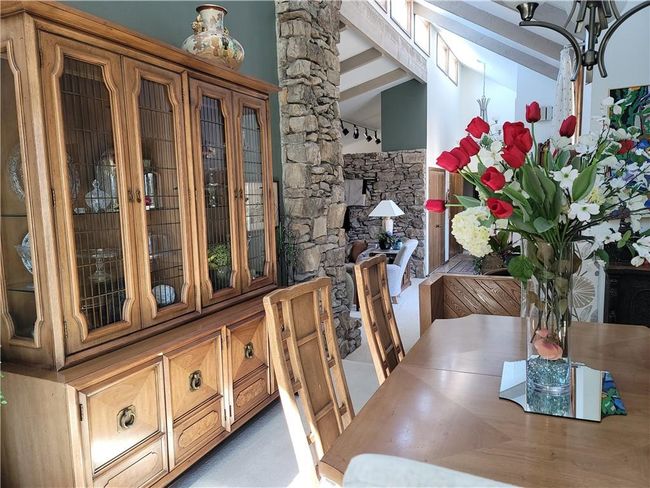 Unfurnished dining area featuring vaulted ceiling with beams | Image 10