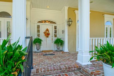 Stucco front. Beautiful millwork and arched transom windows. | Image 3