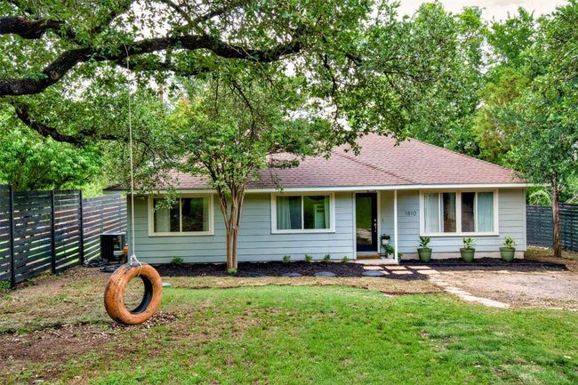 Single story home with roof with shingles, fence, a front yard, and cooling unit | Image 16