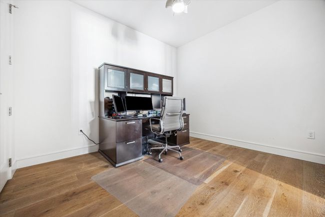 Office featuring ceiling fan, wood finished floors, and baseboards | Image 11
