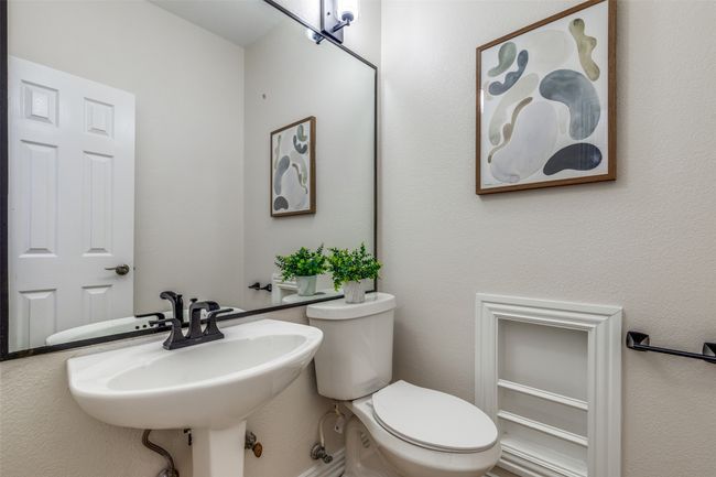 Bathroom featuring a sink and toilet | Image 13