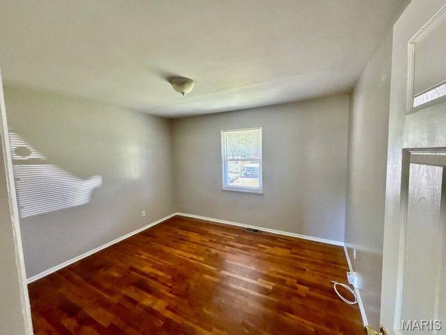 Empty room with wood finished floors and baseboards | Image 5