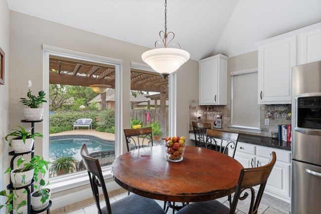 Eat in kitchen dining overlooking the beautiful pool | Image 16