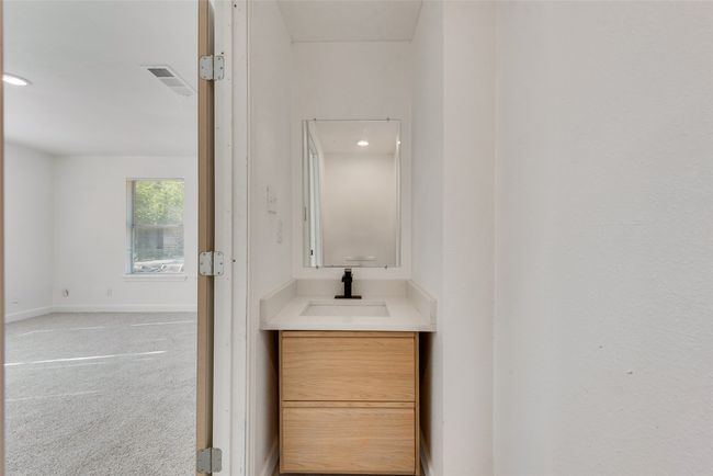 Bathroom featuring baseboards, vanity, visible vents, and recessed lighting | Image 17