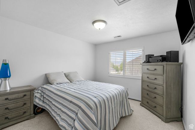 Bedroom featuring light colored carpet and visible vents | Image 31