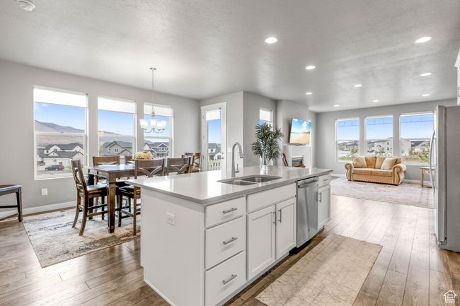 Kitchen featuring hardwood / wood-style floors, a sink, a notable chandelier, and appliances with stainless steel finishes | Image 14