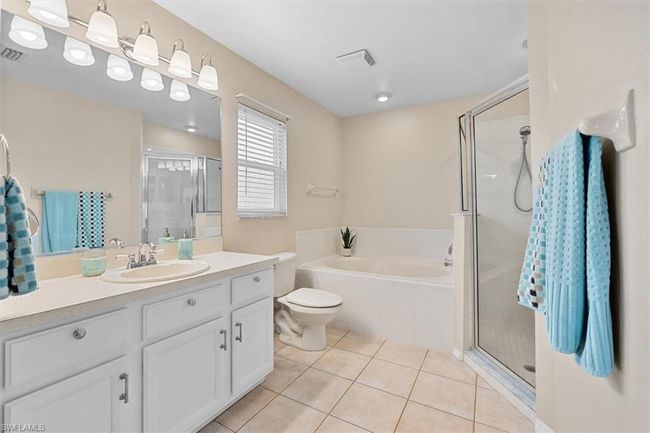 Full bath featuring a stall shower, tile patterned flooring, visible vents, and a bath | Image 24