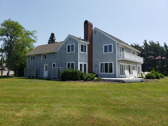 Back of property featuring a yard, a chimney, and a balcony | Image 9