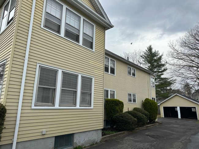 Side view of the building from the driveway showing the two car detached garage | Image 17