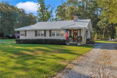 Ranch-style house featuring a front lawn | Image 1