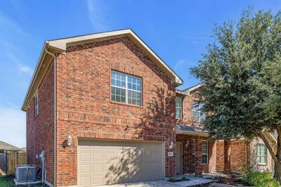 View of front property featuring central air condition unit and a garage | Image 2