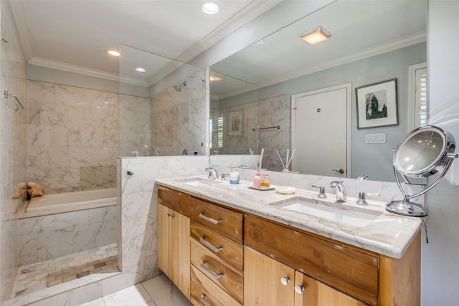 Bathroom featuring ornamental molding, separate shower and tub, vanity, and tile walls | Image 18