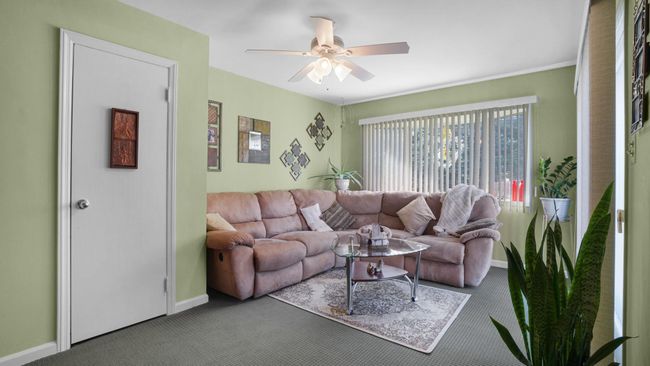 Living room featuring carpet floors, baseboards, and ceiling fan | Image 12