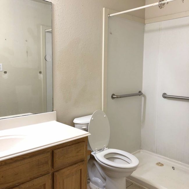 Bathroom with a stall shower, toilet, and vanity | Image 11