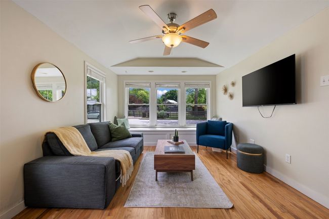 Wood flooring throughout the living room. | Image 5