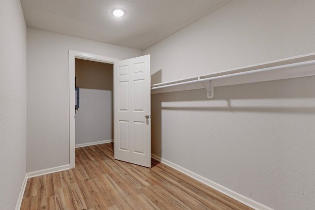 Walk in closet featuring light wood-type flooring | Image 18