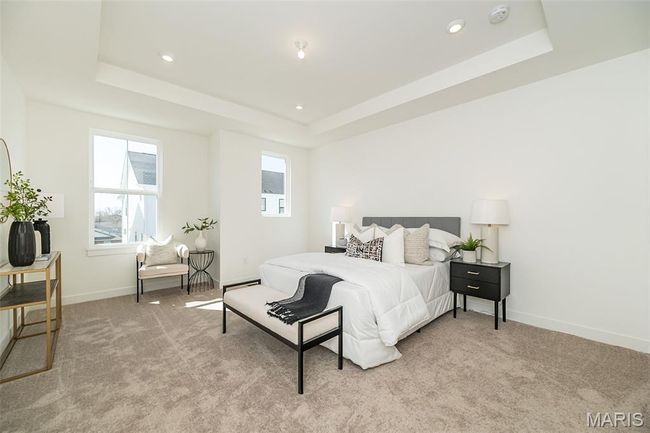 Bedroom featuring a tray ceiling, light carpet, and recessed lighting | Image 22