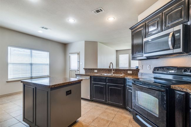 Kitchen with stainless steel appliances, plenty of natural light, a peninsula, a center island, and recessed lighting | Image 11