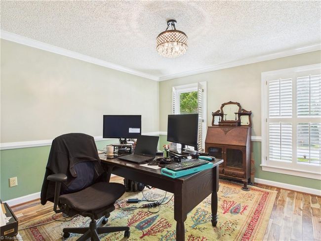 Den beside the kitchen currently being used as an office. | Image 13