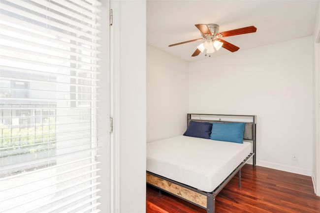 Bedroom featuring wood finished floors, baseboards, and a ceiling fan | Image 33