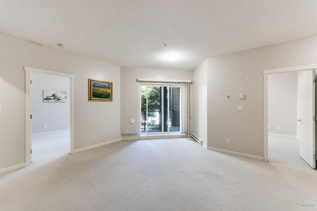 Spare room with light colored carpet and a baseboard radiator | Image 10