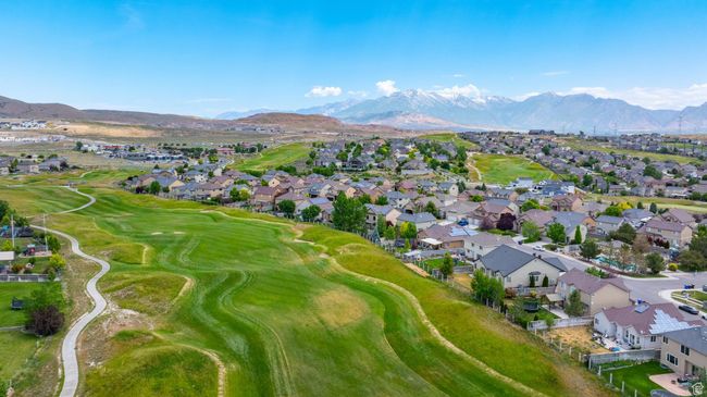 Aerial view of property's location with nearby suburban area, a mountain backdrop, and a local golf course | Image 43