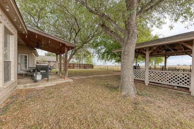 View of yard featuring a gazebo, ceiling fan, and a patio area | Image 35